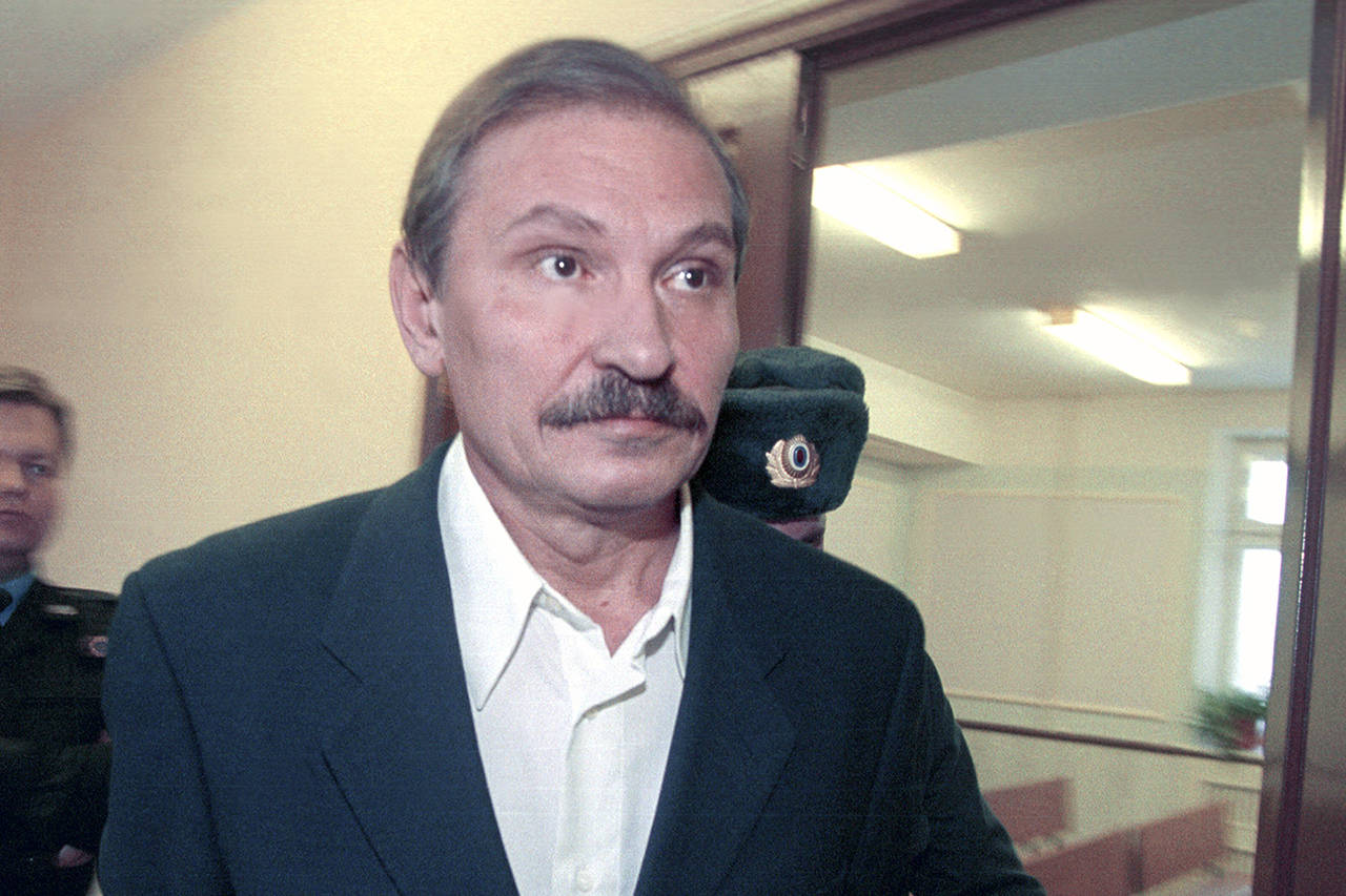 In this 2000 photo, ex-deputy director general of Aeroflot airlines company Nikolai Glushkov leaves the Lefortovsky court escorted by police officers in Moscow. British police say they are treating the death of the London-based Russian businessman as a homicide. (Pavel Smertin/Kommersant Photo via AP, file)