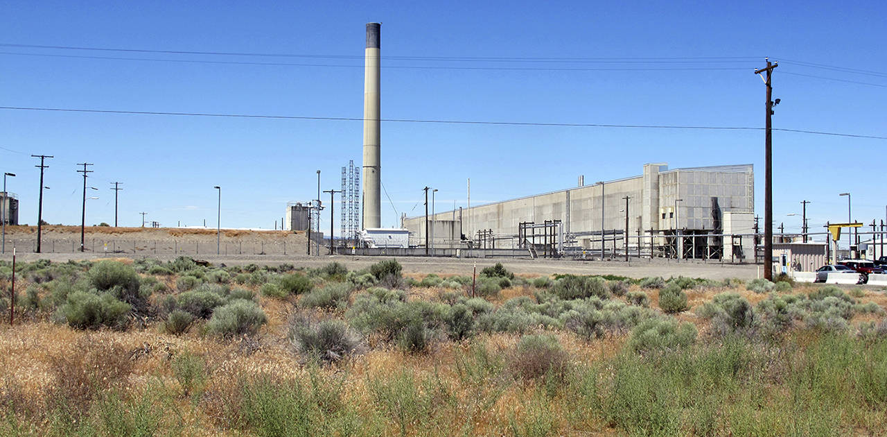 The Plutonium Uranium Extraction Plant (right) stands adjacent to a dirt-covered rail tunnel (left) containing radioactive waste, amidst desert plants on the Hanford Nuclear Reservation near Richland. (AP Photo/Nicholas K. Geranios, File)
