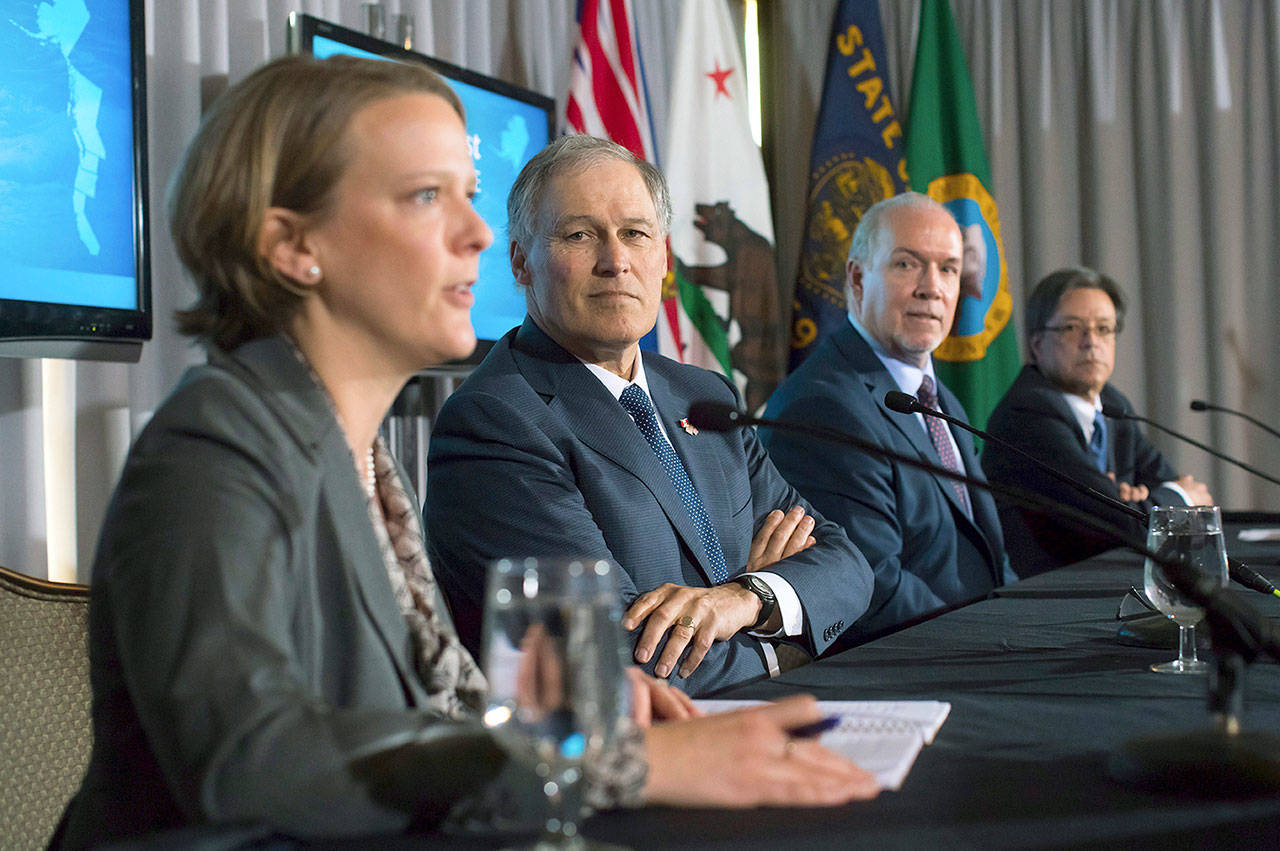 From left, Oregon Energy Director Janine Benner, Washington State Gov. Jay Inslee, British Columbia Premier John Horgan and California Secretary for Environmental Protection Matt Rodriquez attend a news conference in Vancouver on Friday. (Darryl Dyck/The Canadian Press via AP)