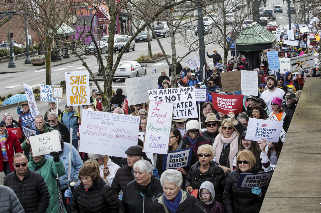 Thousands of protesters walk along Hewitt Avenue near the Angel of the Winds Arena in downtown Everett during a March for Our Lives rally on Saturday. (Ian Terry / The Herald)
