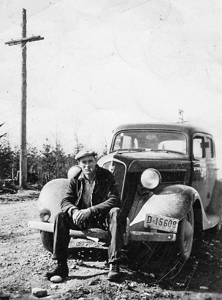 Orville Short sits on a car near the family home at Emander, which was near today’s Mariner High School. (Family photo)
