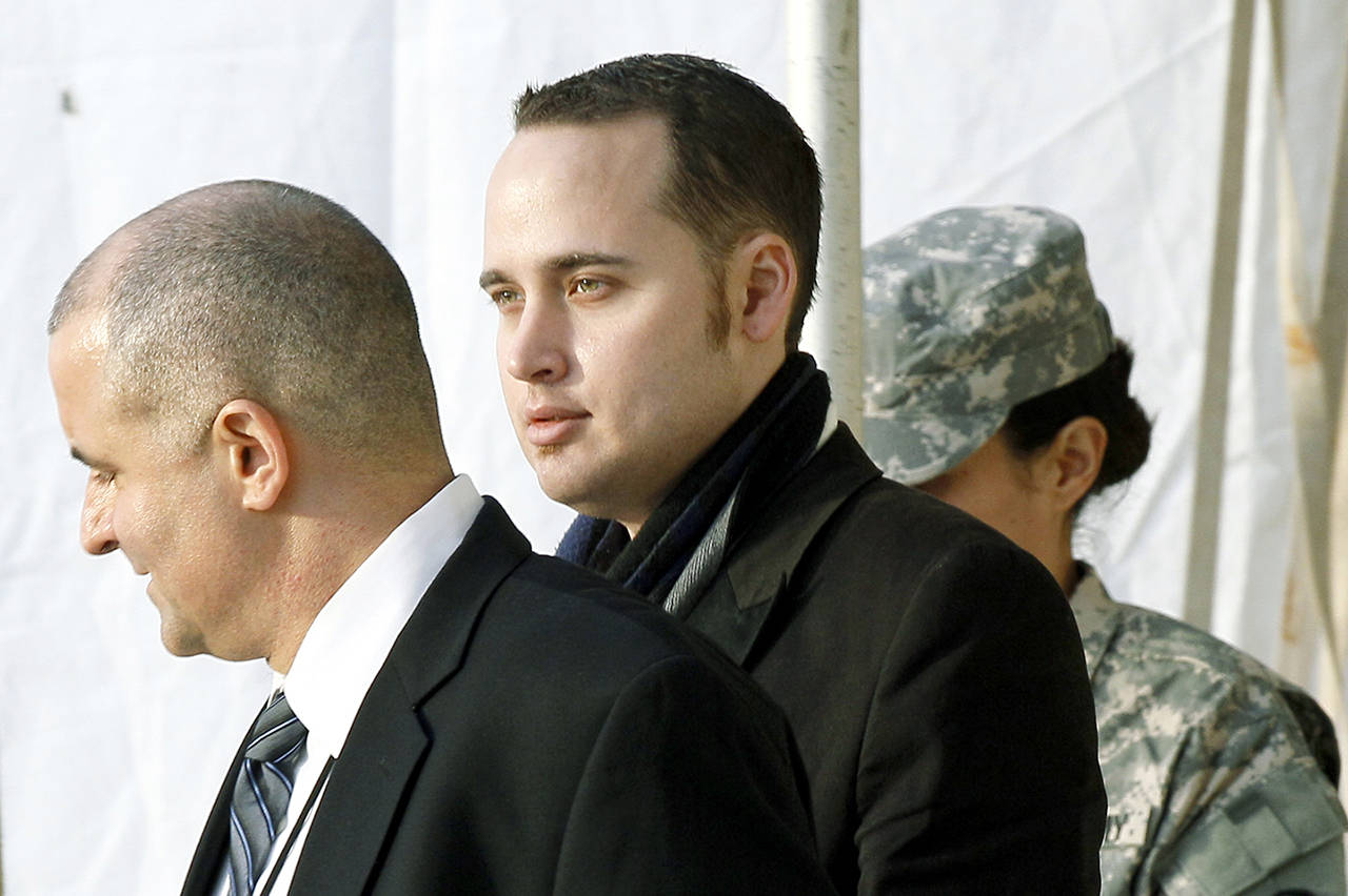 Adrian Lamo (center) walks out of a courthouse in Fort Meade, Maryland, on Dec. 20, 2011, after testifying at a military hearing to determine if Army Pfc. Bradley Manning would face court-martial for his alleged role in the WikiLeaks classified leaks case. (AP Photo/Patrick Semansky)