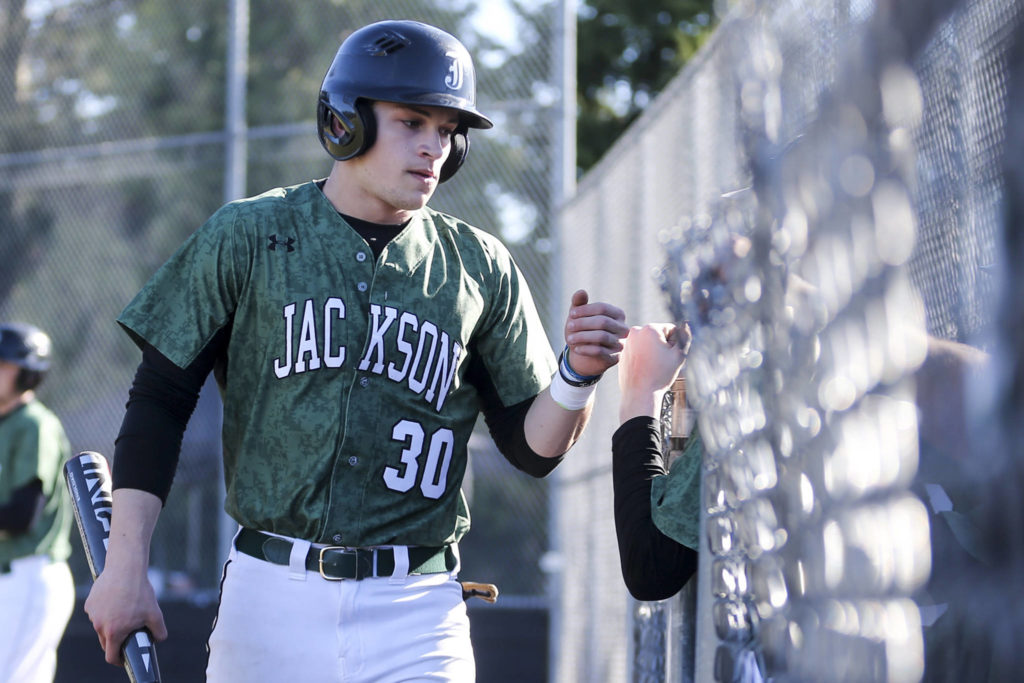 Carter Booth, Jackson senior outfielder, makes his way to the dugout after scoring at Jackson High School against Marysville-Getchell on March 15. (Kevin Clark / The Herald)

