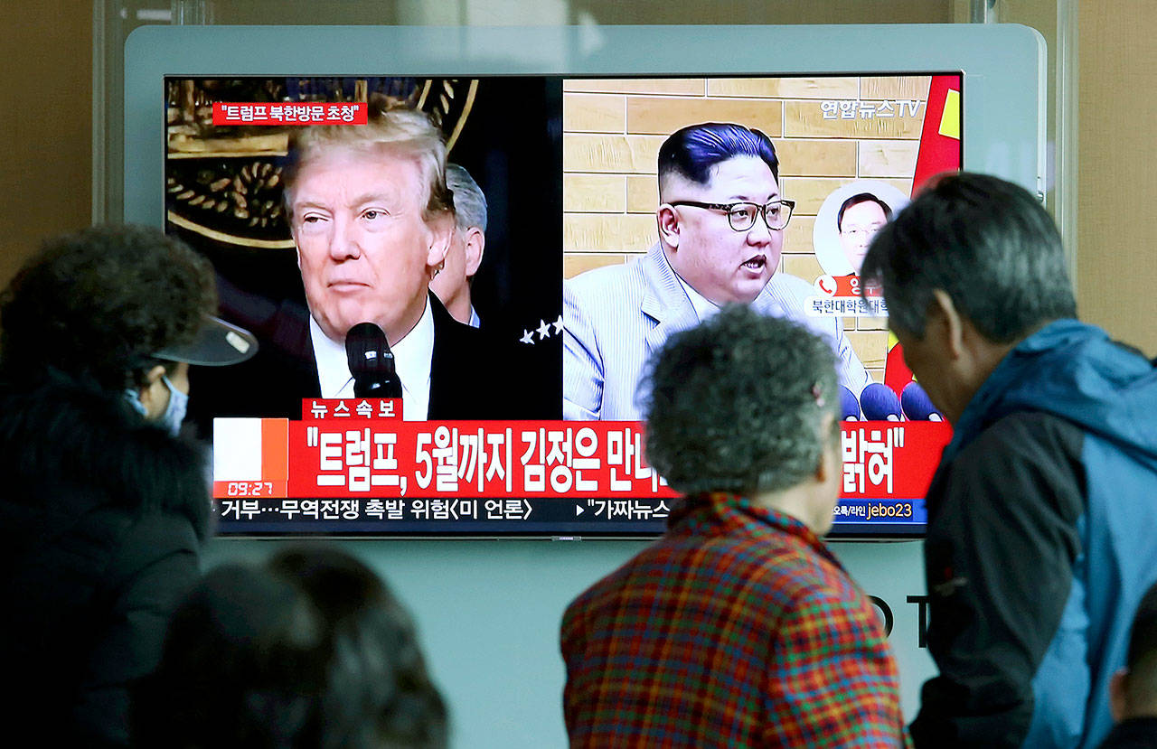 People watch a TV screen showing U.S. President Donald Trump and North Korean leader Kim Jong Un at the Seoul Railway Station in Seoul, South Korea, March 9. (AP Photo/Ahn Young-joon)