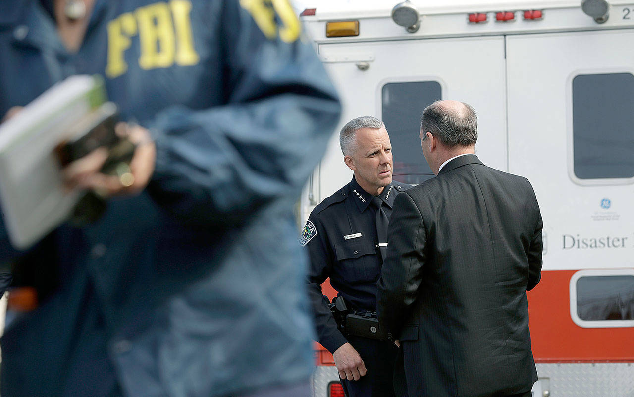 Interim Austin police Chief Brian Manley (left) talks with FBI Special Agent in Charge Christopher Combs near the site of Sunday’s explosion Monday in Austin, Texas. (AP Photo/Eric Gay)