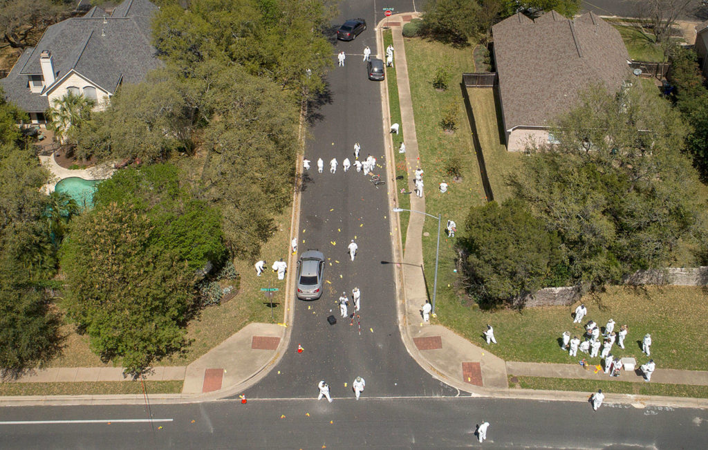 Investigators on Monday work at the scene of a bomb explosion on Dawn Song Drive in Austin, Texas, where two men were seriously injured on Sunday. (Jay Janner/Austin American-Statesman via AP) 
