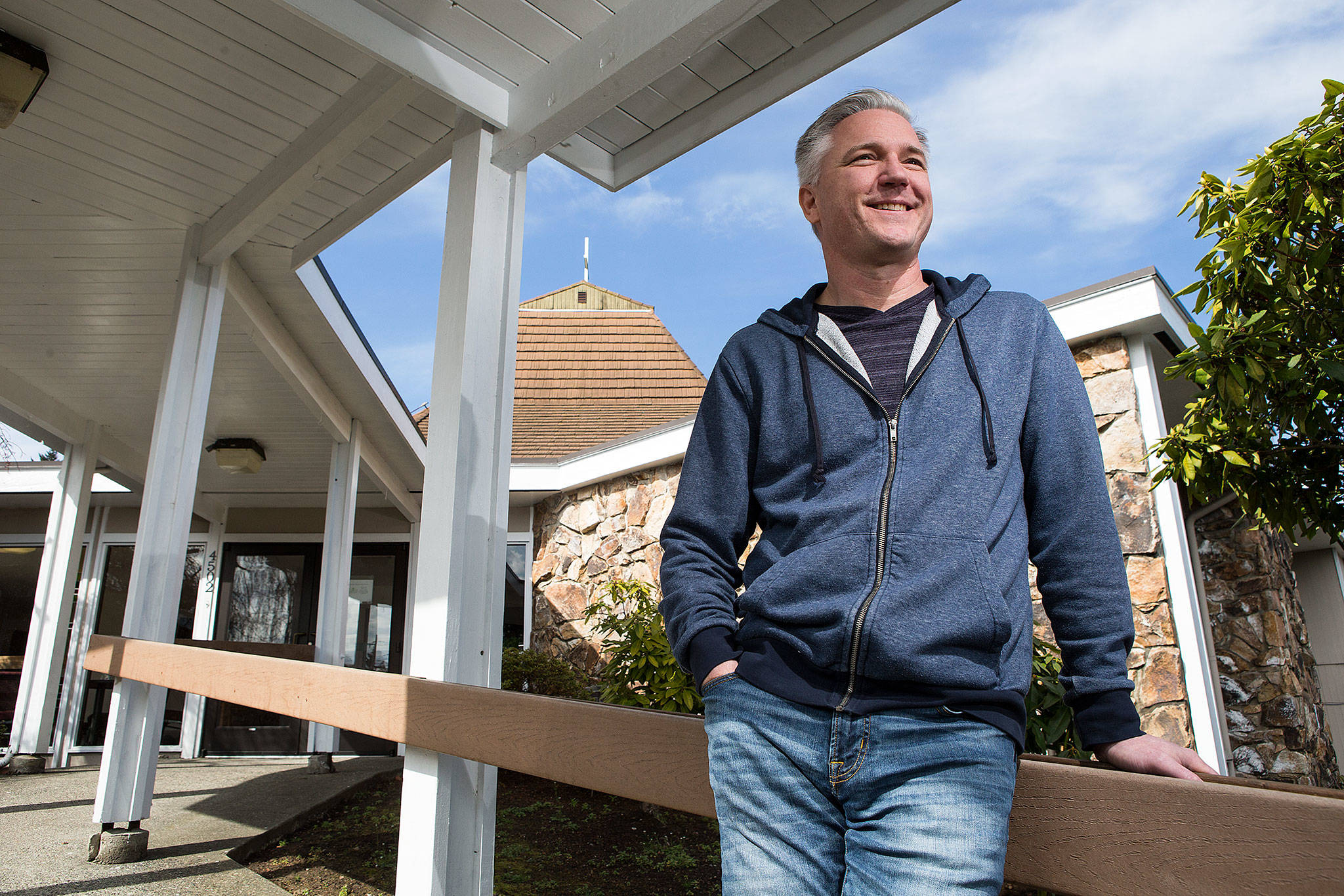 Pastor Bill Walles sits in front of his new church in the 4500 block of Rucker Avenue on Wednesday in Everett. What was the Sanctuary Covenant Church is now Hope Covenant Church, which was what it was called in Lake Stevens. (Andy Bronson / The Herald)