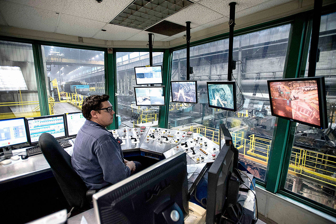 A hot mill technician works from an operator pulpit at the Direct Strip Production Complex at Essar Steel Algoma in Sault Ste. Marie, Ontario, on March 14, 2018. (Justin Tang/Canadian Press)