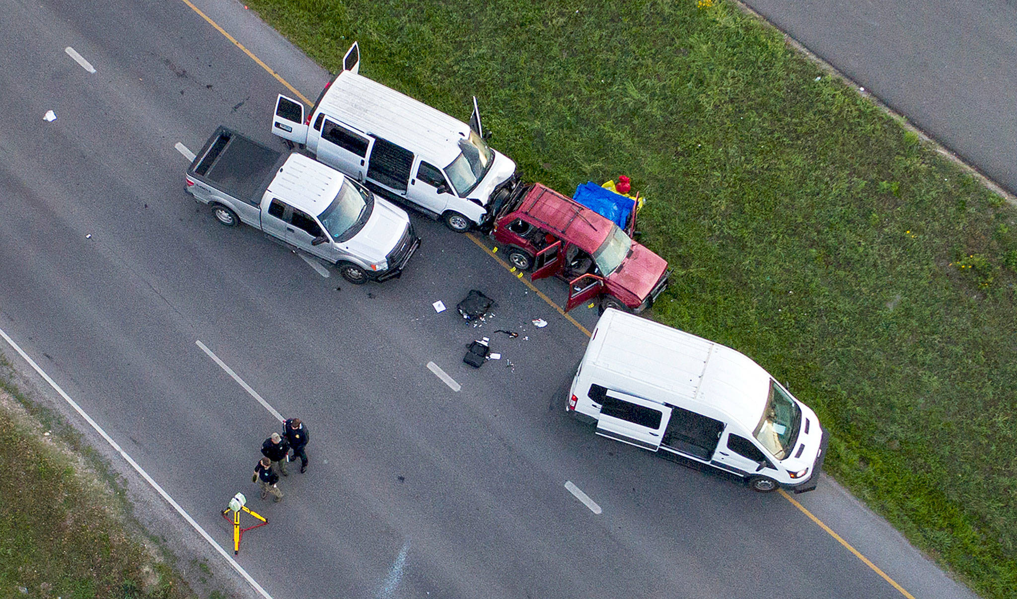 Officials investigate near a vehicle (center) in which the suspect in the deadly bombings that terrorized Austin blew himself up in Round Rock, Texas, on Wednesday. (Jay Janner/Austin American-Statesman via AP)