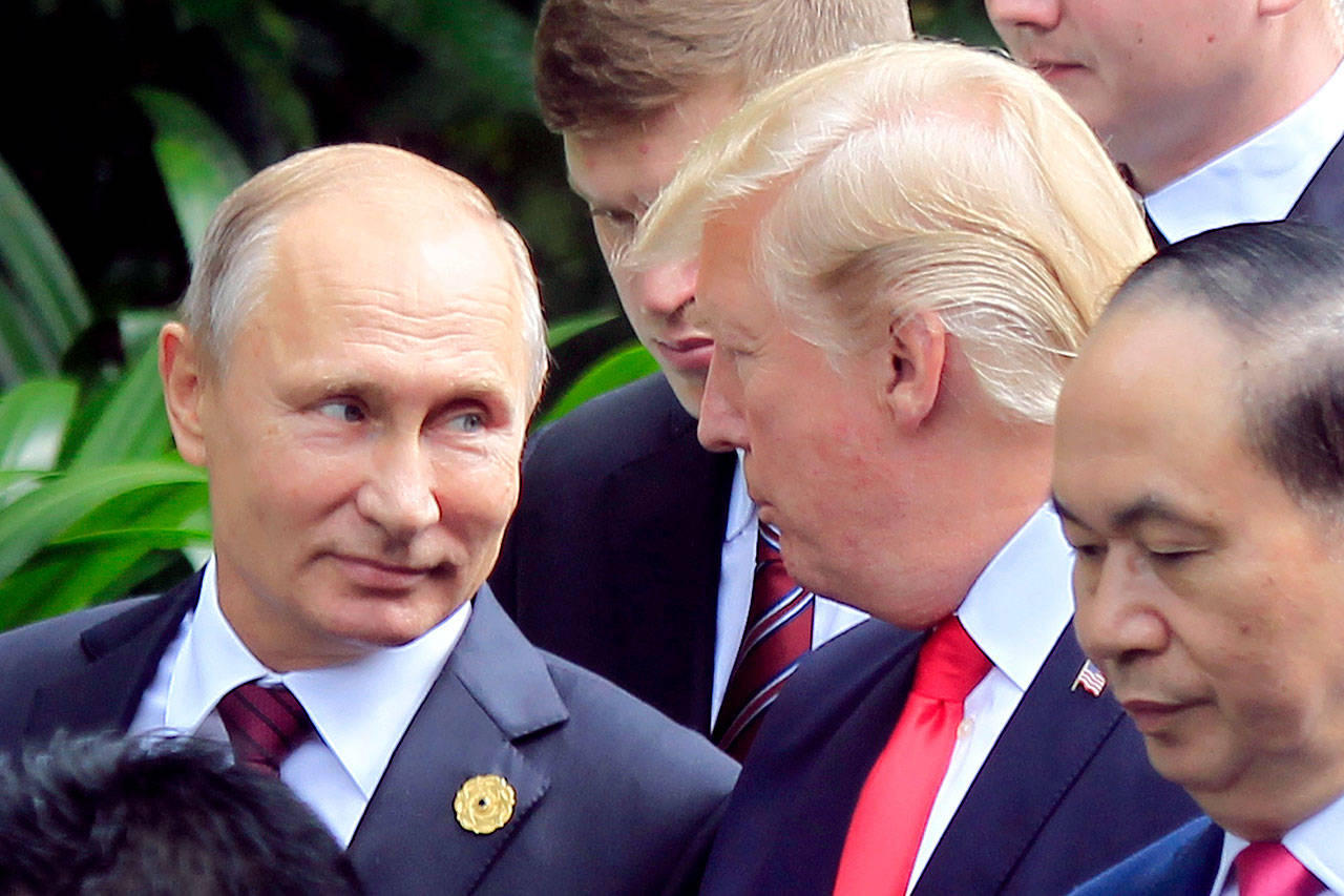 Russian President Vladimir Putin (left) and U.S. President Donald Trump talk during the Asia-Pacific Economic Cooperation (APEC) Summit in Danang, Vietnam, on Nov. 11. (AP Photo/Hau Dinh)