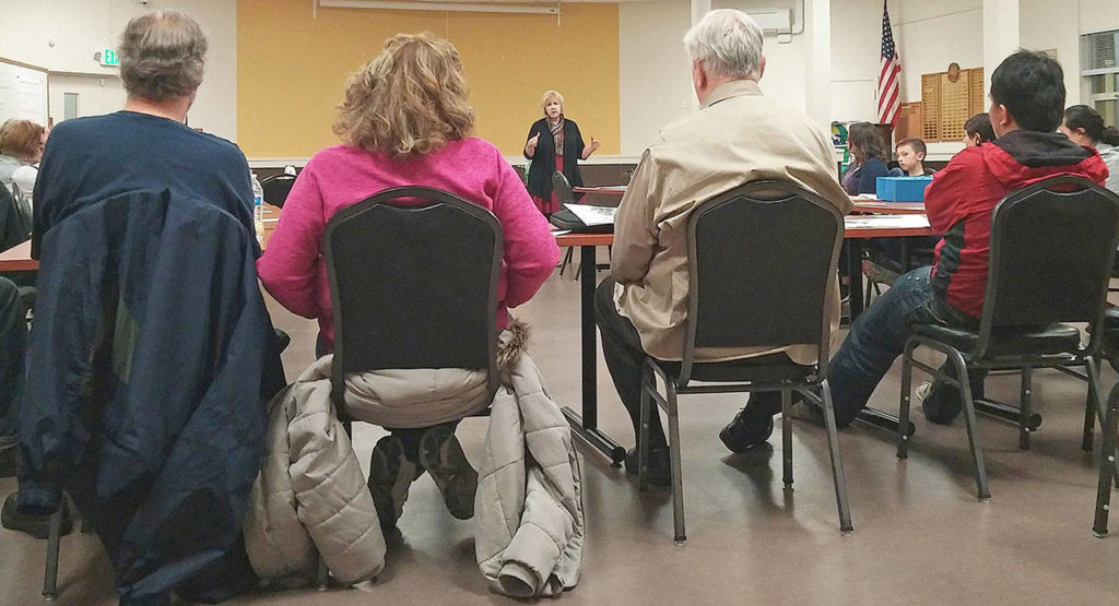 Cammy Hart-Anderson, of Snohomish County human services, updates the Delta Neighborhood Association on Tuesday about plans to put addiction treatment beds at a site on 10th Street in Everett. (Rikki King / The Herald)
