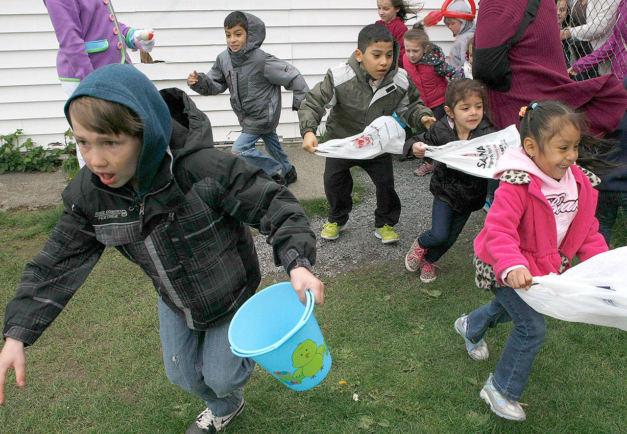 Kids race to find eggs during a Easter egg hunt in Everett in April 2014. (Herald file photo)