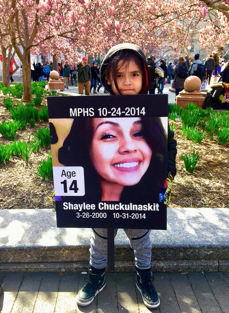 A young member of the Tulalip Tribes holds a sign in honor of Shaylee Chuckulnaskit, a victim of the 2014 Marysville Pilchuck High School shooting, during Saturday’s March for Our Lives in Washington, D.C. (Micheal Rios photo)
