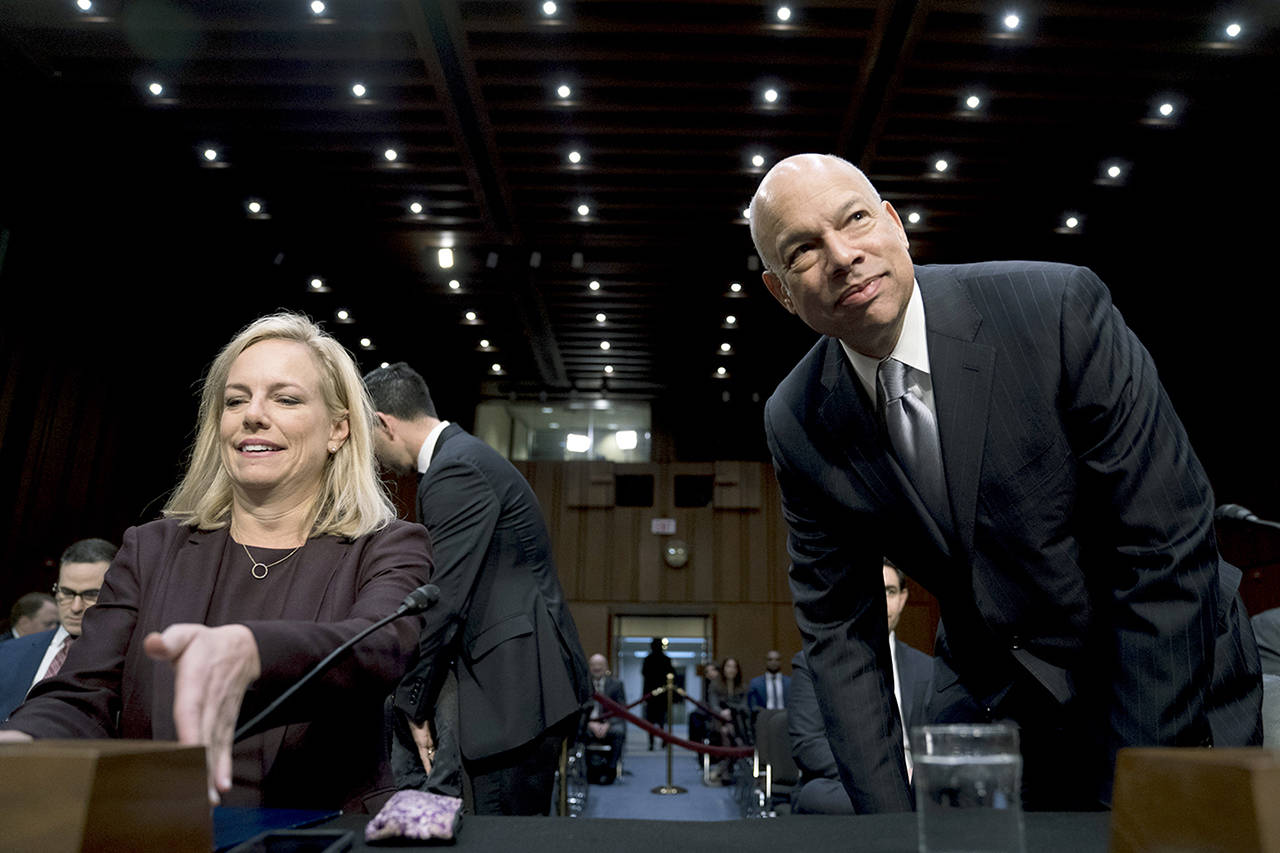 Homeland Security Secretary Kirstjen Nielsen (left) and former Homeland Security Secretary Jeh Johnson (right) arrive for a Senate Intelligence Committee hearing on election security on Capitol Hill in Washington on Wednesday. (AP Photo/Andrew Harnik)
