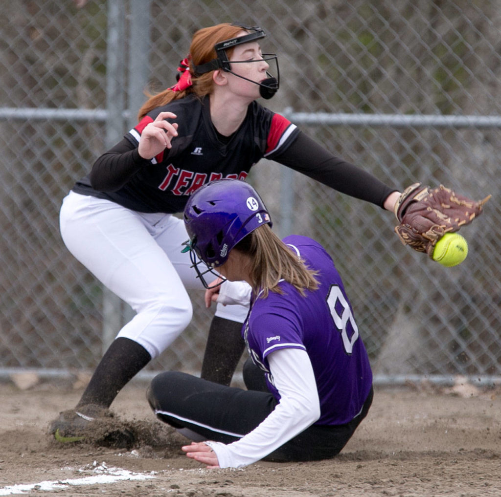 Edmonds-Woodway’s Kaitlyn Rust arrives just ahead of Mountlake Terrace’s Laney Flynn’s tag during a Wesco 3A softball game Wednesday in Mountlake Terrace. Rust and the Warriors won 7-5 in eight innings. (Kevin Clark / The Herald)
