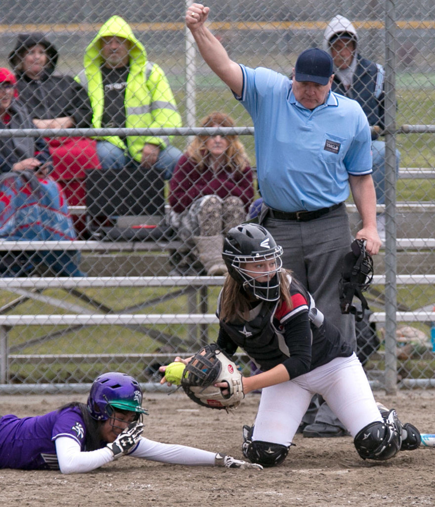 Edmonds-Woodway’s Sofia Chamorro (left) is tagged out at the plate by Mountlake Terrace catcher Jamie Bingaman during a Wesco 3A softball game Wednesday in Mountlake Terrace. Chamorro and the Warriors won 7-5 in eight innings. (Kevin Clark / The Herald)
