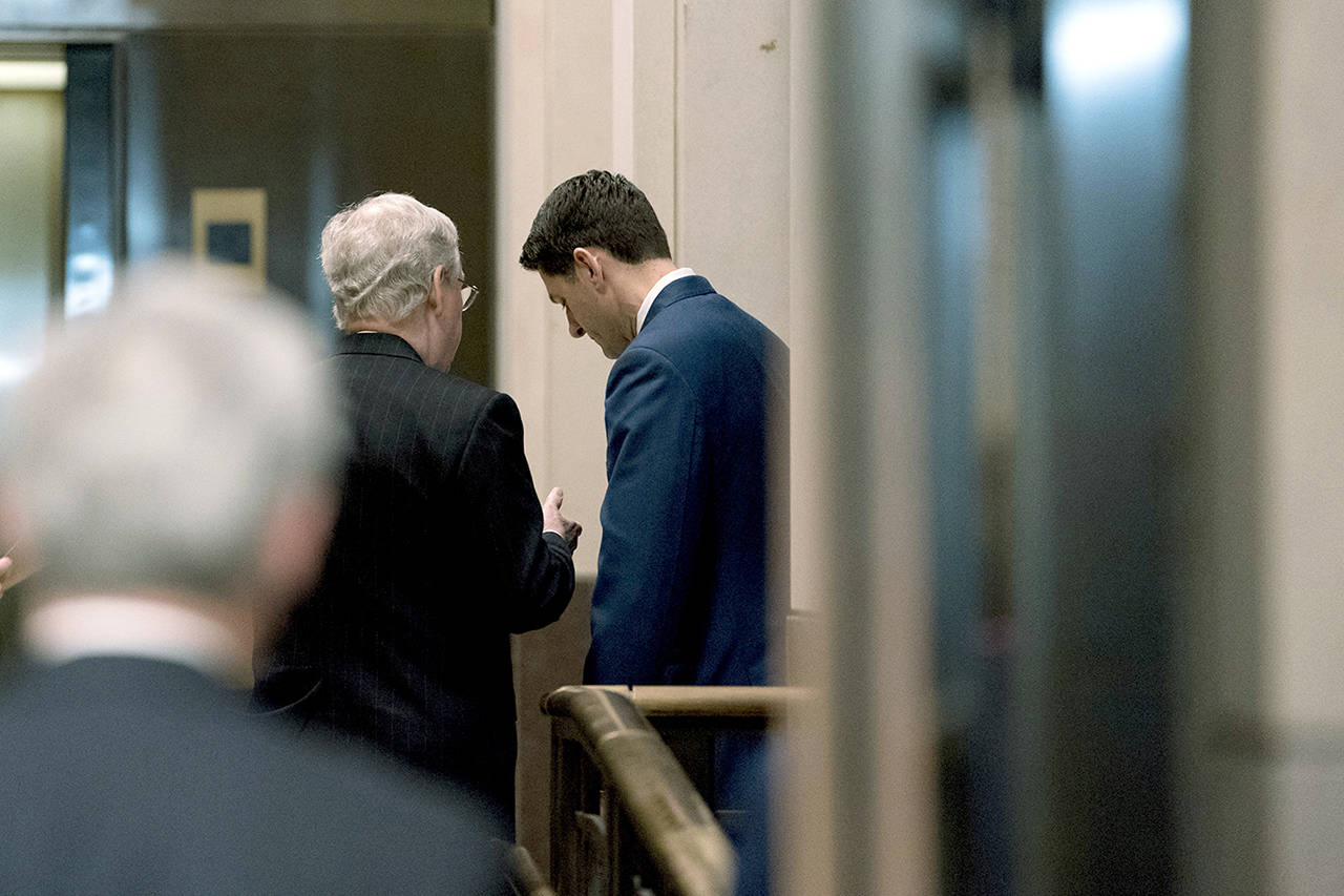 Senate Majority Leader Mitch McConnell of Kentucky (left) speaks with House Speaker Paul Ryan of Wisconsin (right) behind closed doors following a Congressional Gold Medal Ceremony honoring the Office of Strategic Services in Emancipation Hall on Capitol Hill in Washington on Wednesday. (AP Photo/Andrew Harnik)