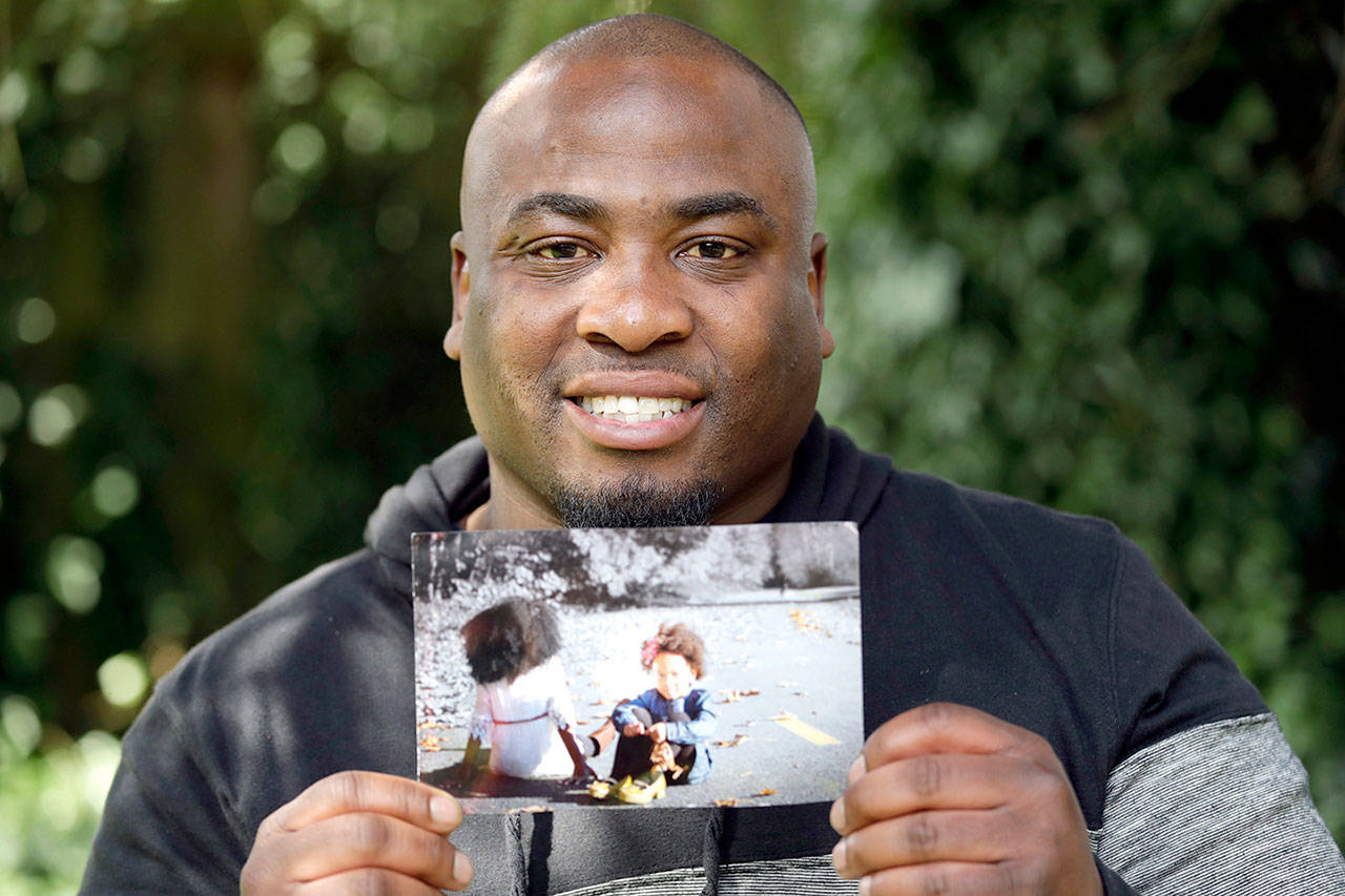 Orlando Wright holds a photo of his 4-year-old daughter, Jannah Wright, as he poses for a photo at his home in Kent. (AP Photo/Elaine Thompson)