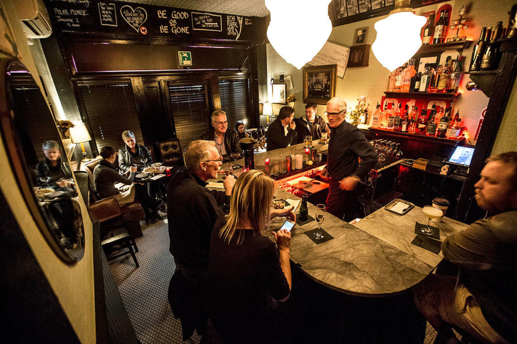 Daphne’s in Edmonds is seen on a recent Wednesday evening. With just a few seats around the bar and two small tables, the space provides a cozy experience. (Ian Terry / The Herald)
