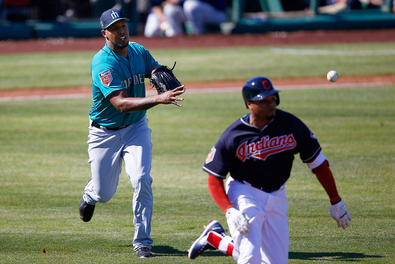 Cleveland’s Rajai Davis beats out an infield single as Seattle pitcher Juan Nicasio makes a late toss to first base during the fourth inning of a Feb. 28 game in Goodyear, Ariz. (AP Photo/Ross D. Franklin)