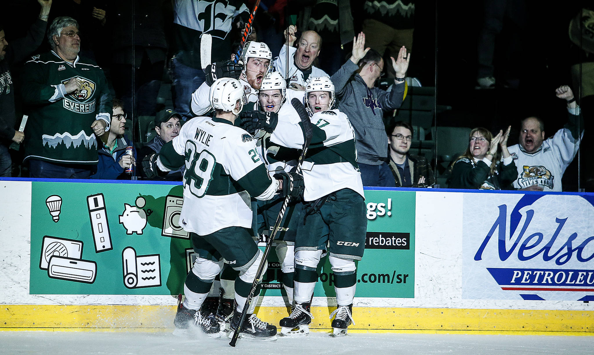 The Silvertips’ Garrett Pilon (center) celebrates his goal with teammates in the first period of a playoff series against the Thunderbirds on March 23, 2018, at Angel of the Winds Arena in Everett. (Ian Terry / The Herald)
