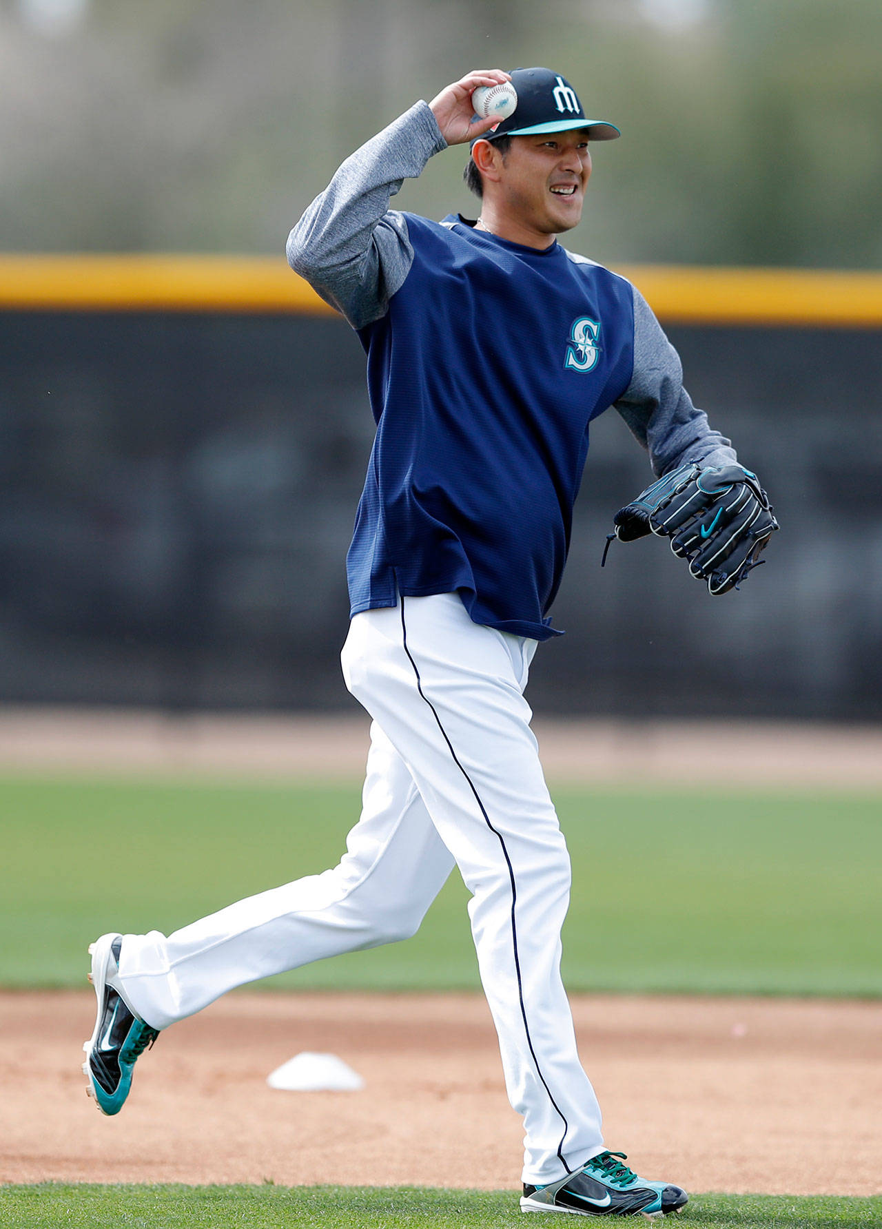 Mariners starting pitcher Hisashi Iwakuma runs on the field during a spring training workout on Feb. 19, 2018, in Peoria, Ariz. (AP Photo/Charlie Neibergall)