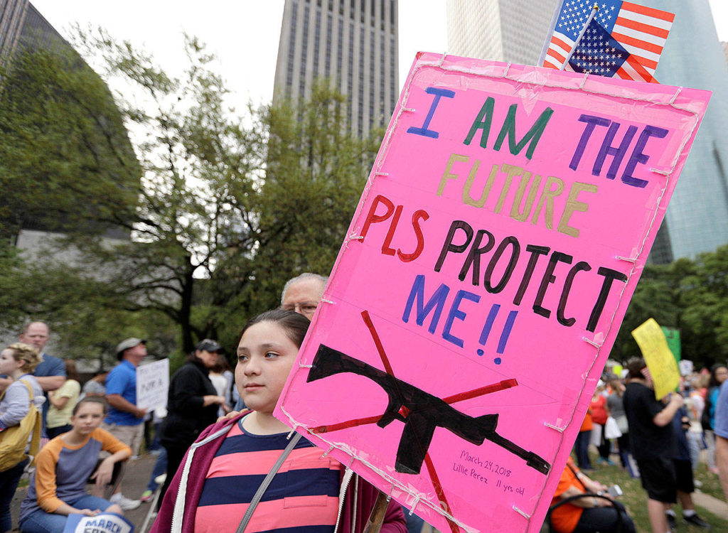 Lillie Perez, 11, holds a sign during a March for Our Lives protest for gun legislation and school safety Saturday in Houston. (AP Photo/David J. Phillip)
