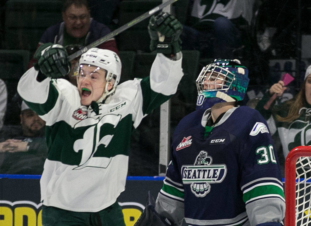 Everett’s Sean Richards celebrates a goal with Seattle’s Liam Hughes looking on in the first period of a playoff game on March 24, 2018, at Angel of the Winds Arena in Everett. (Kevin Clark / The Herald)
