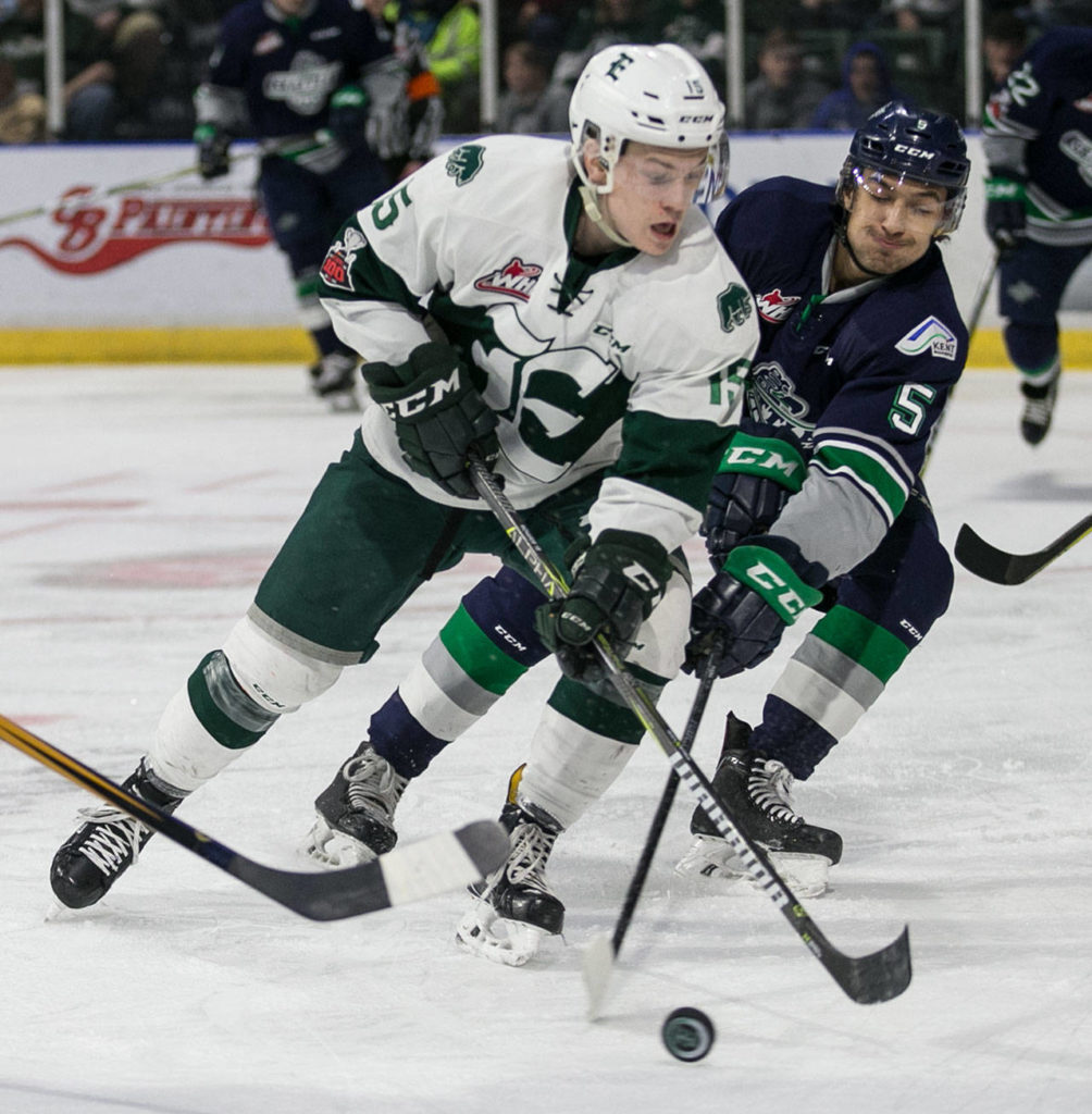 Everett’s Sean Richards fends off Seattle’s Jarret Tyszka in the first period of a playoff game on March 24, 2018, at Angel of the Winds Arena in Everett. (Kevin Clark / The Herald)

