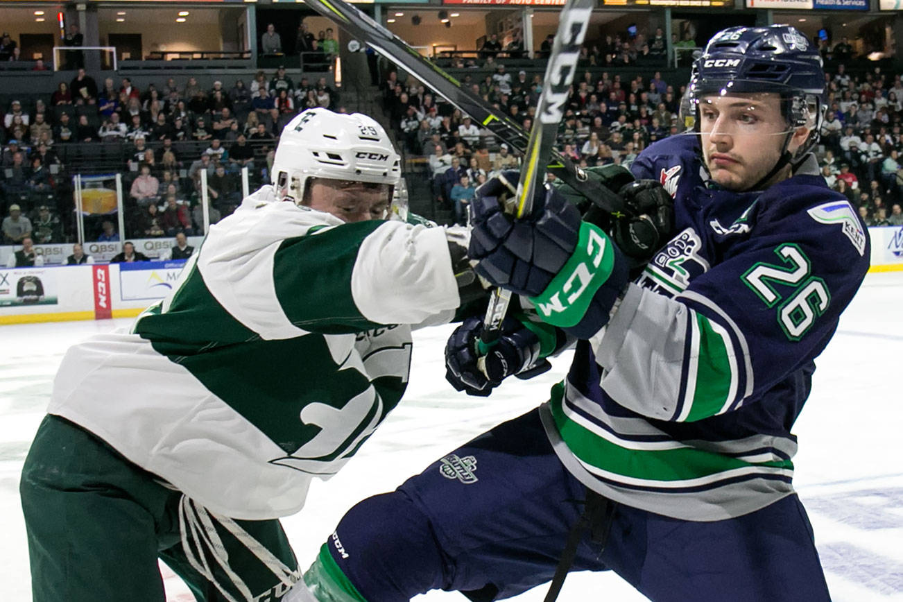 Everett’s Kevin Davis shoves Seattle’s Nolan Volcan in the first period at Angel of the Winds Arena Saturday night in Everett on March 24, 2018. (Kevin Clark / The Daily Herald)