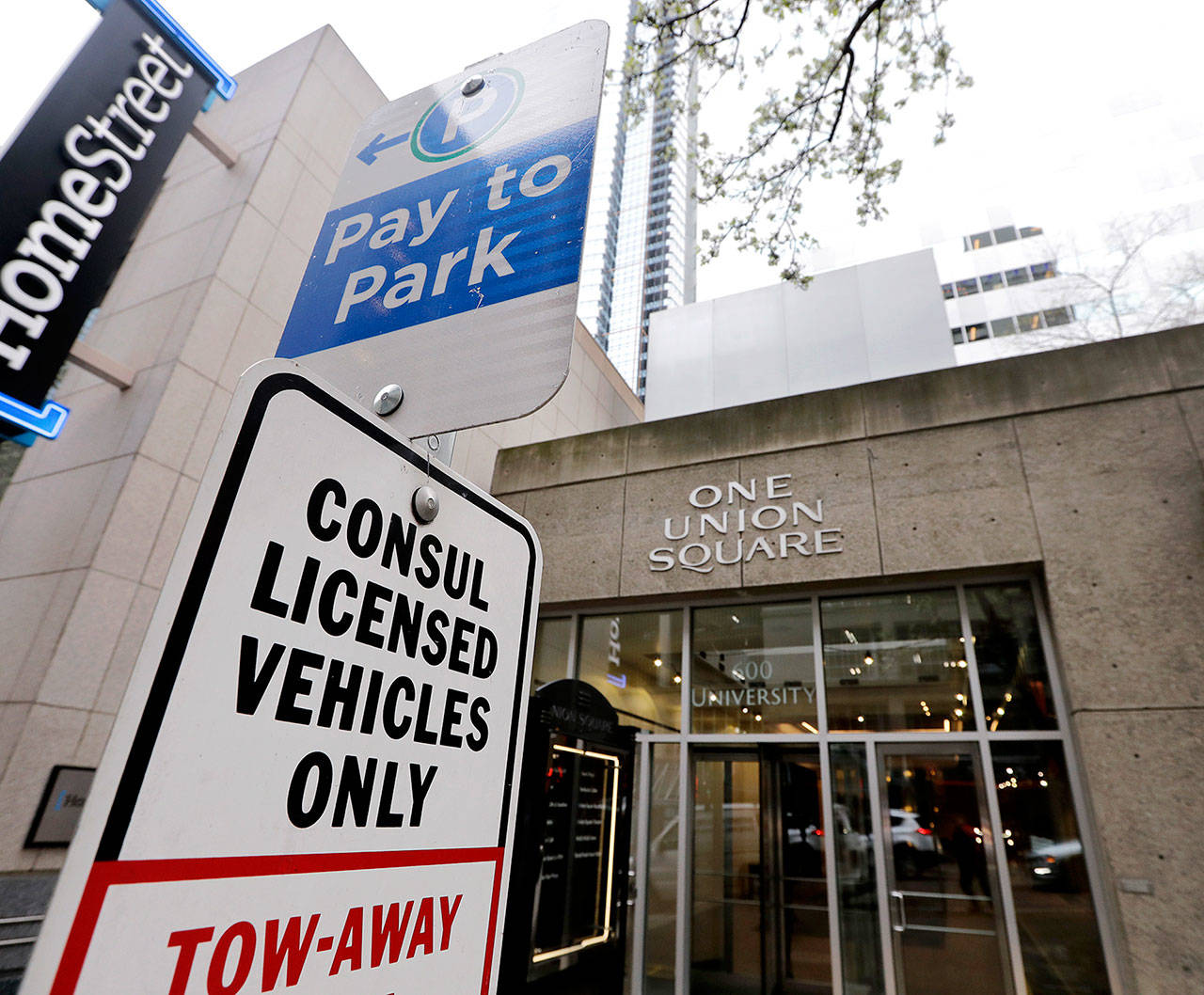 Parking for consul vehicles is reserved outside One Union Square, the downtown Seattle building that houses the Russian consulate in Seattle. (AP Photo/Elaine Thompson)