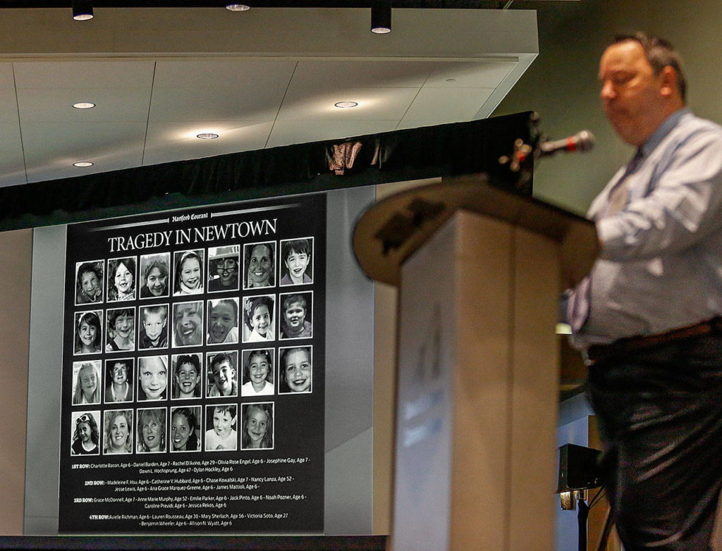 During Newtown Police Capt. Christopher Vanghele’s talk Wednesday, he showed a photo array of victims from the Sandy Hook tragedy, including 20 first-graders and six adults. (Dan Bates / The Herald)
