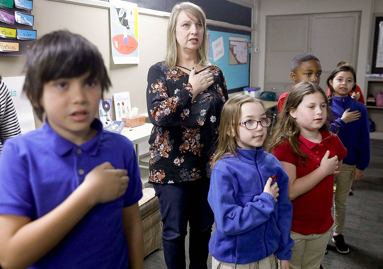 Third grade teacher Lisa Sander says the pledge of allegiance with her class at Mayo Demonstration School in Tulsa, Oklahoma, on March 12. (Mike Simons/Tulsa World)