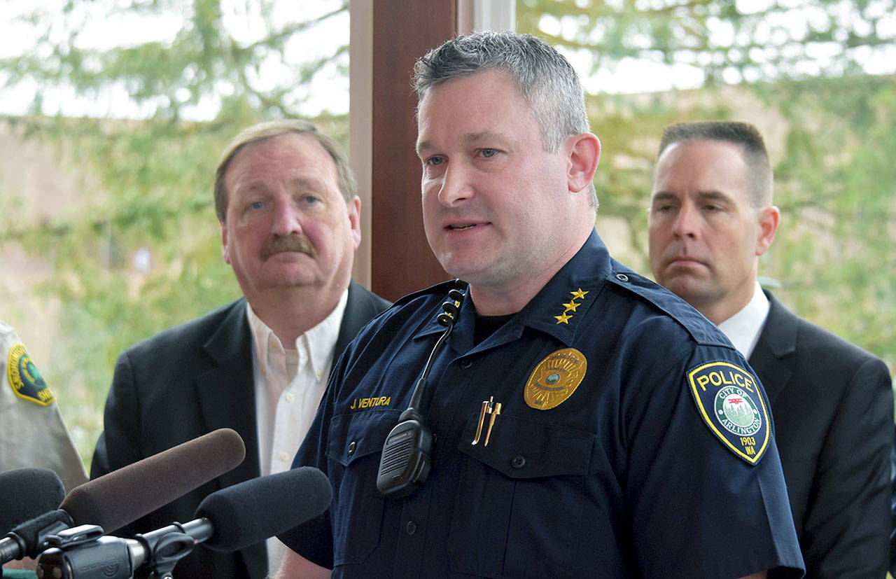 ”Traditionally, law enforcement has been used as a hammer,” Arlington Police Chief Jonathan Ventura said at a news conference Thursday. “And as you know, when you’re a hammer, everything looks like a nail.” Ventura praised a homeless outreach program that’s expanding into north Snohomish County. He’s flanked by County Executive Dave Somers (left) and Marysville Mayor Jon Nehring. (Caleb HUtton / The Herald)