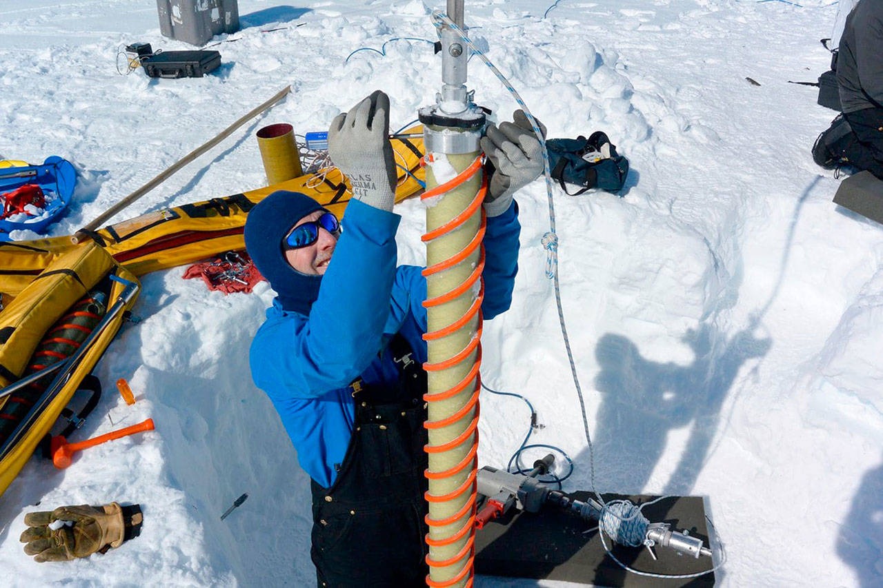 Lead scientist Erich Osterberg prepares to drill an ice core during the 2016 Greenland Traverse for Accumulation and Climate Studies. (Forrest McCarthy)