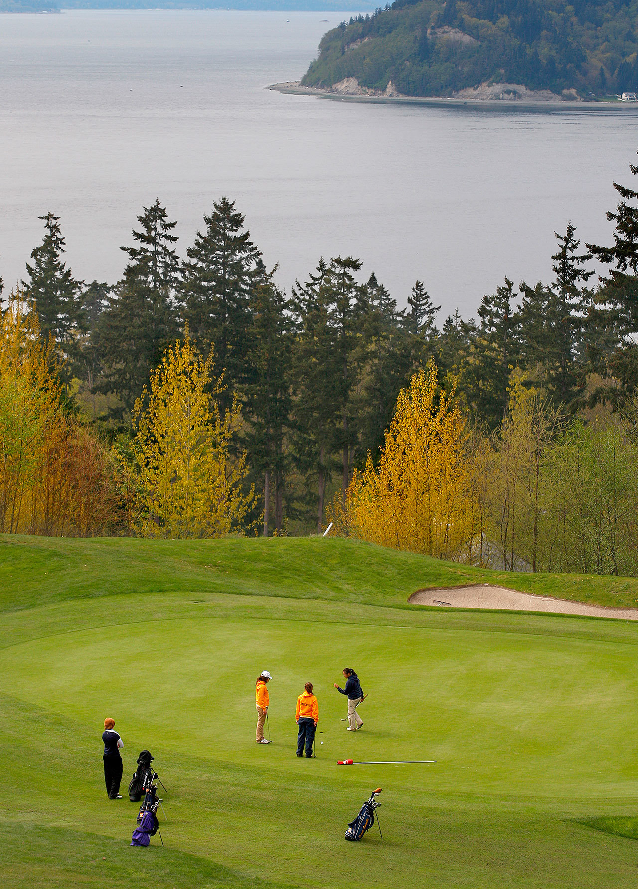 A foursome play the 11th green at the Harbour Pointe golf course in Mukilteo. (File photo)