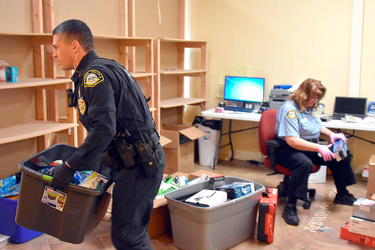 Monroe police raided a gold buying business Friday morning, two years into an investigation led by officer Nathan Erdmann (left). (Caleb Hutton / Herald)