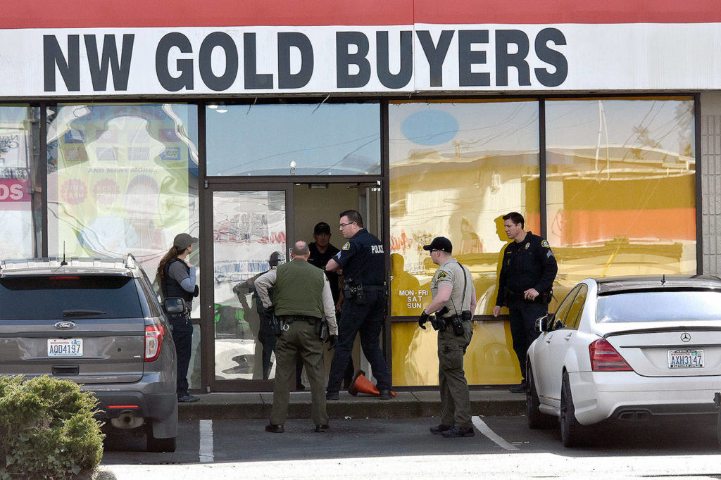 Monroe police raided a gold-buying business Friday morning north of Lynnwood. Officers had been investigating the owner for two years. He is suspected of trafficking in stolen goods. (Caleb Hutton / Herald)

