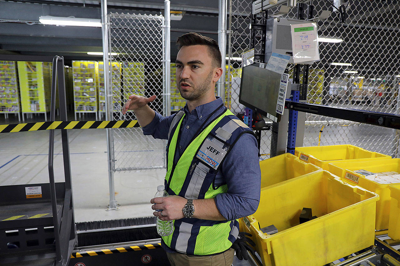 At the Amazon fulfillment center in Monee, Illinois, general manager Jeff Messenger talks about the robots in use there Wednesday. (Terrence James/Chicago Tribune)
