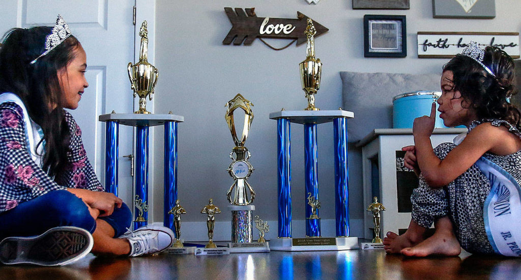 Isabelle, 8, (left) and Aria, 4, have each received trophies for their efforts in pageants. (Dan Bates / The Herald)
