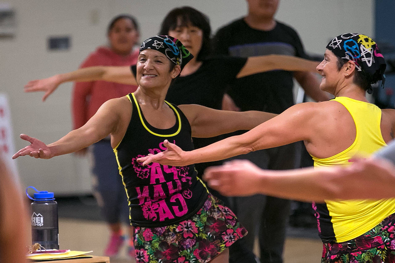 Nancy Isely leads her Spanish Zumba class Monday night at the YMCA in Mukilteo. (Kevin Clark / The Herald)
