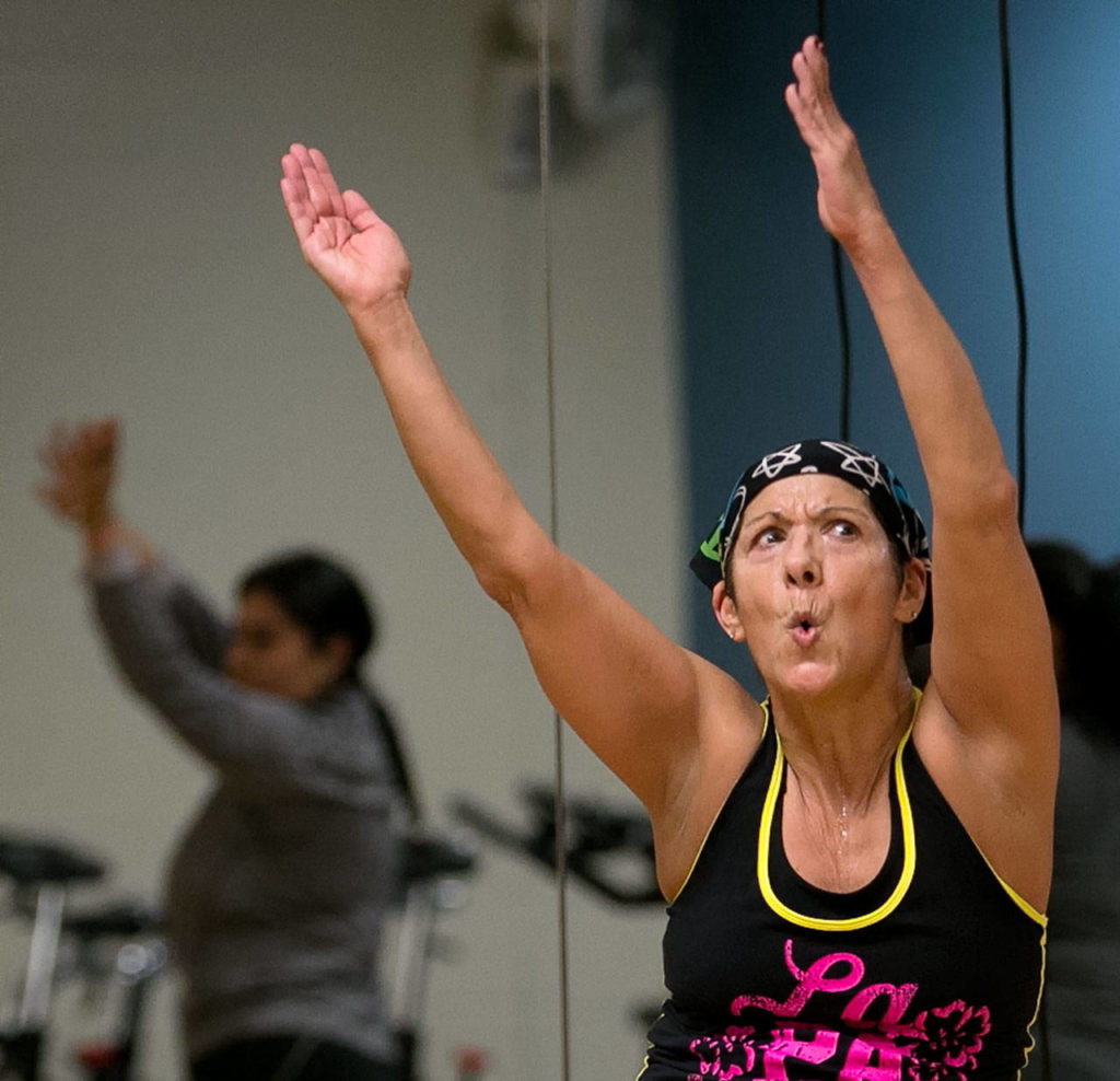 Zumba is a pulsating workout rooted in Latin American dance and music. (Kevin Clark / The Herald)
