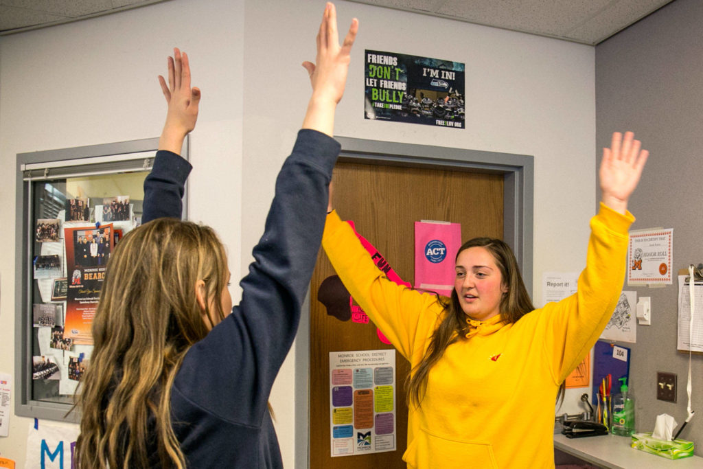 Sarah Reeves (right) directs Samantha Hancock through an examination Monday afternoon during Heather Sevier’s advanced sports medicine class at Monroe High School. (Kevin Clark / The Herald)
