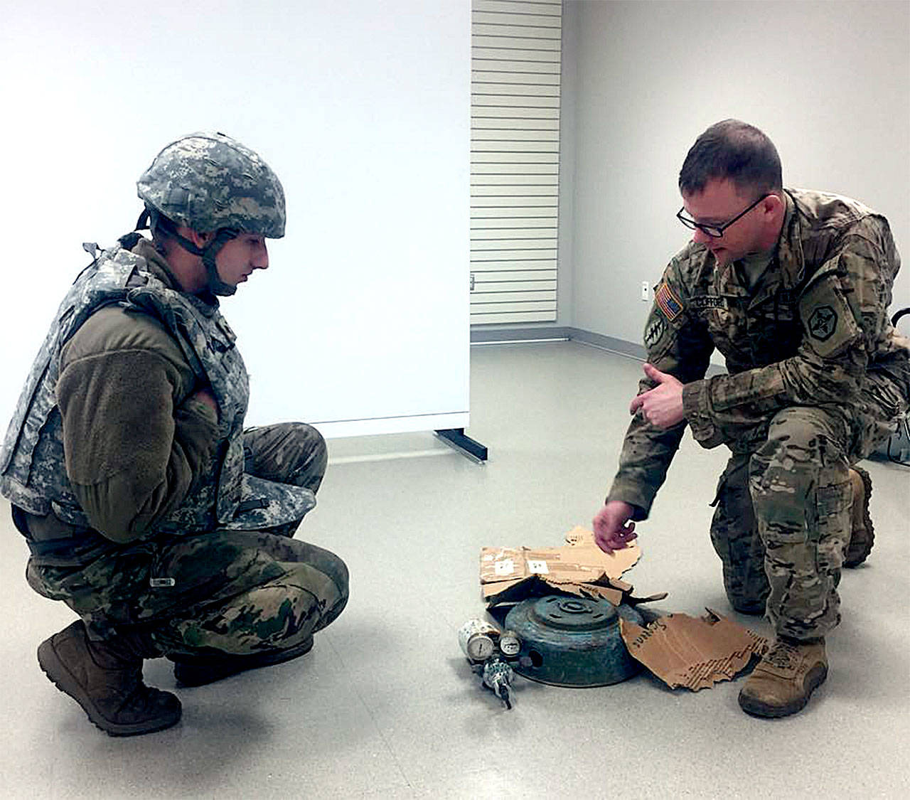 U.S. Army Reserve Spc. Jacob Carr, of Everett, listens as training instructor Staff Sgt. Lance Clifford conducts a class on identifying visual indicators of an improvised explosive device during battle assembly for the 364th Expeditionary Sustainment Command in Marysville, Feb. 25. (Contributed photo)
