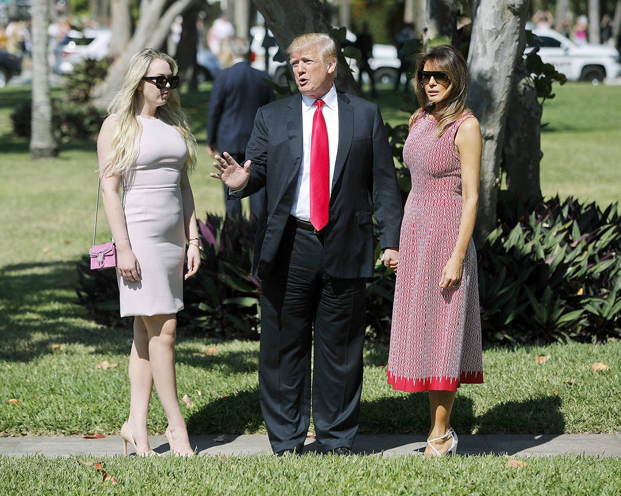 President Donald Trump stops to talk to members of the media as he arrives for Easter services with his daughter Tiffany Trump (left) and first lady Melania Trump at Episcopal Church of Bethesda-by-the-Sea on Sunday in Palm Beach, Florida. (AP Photo/Pablo Martinez Monsivais)