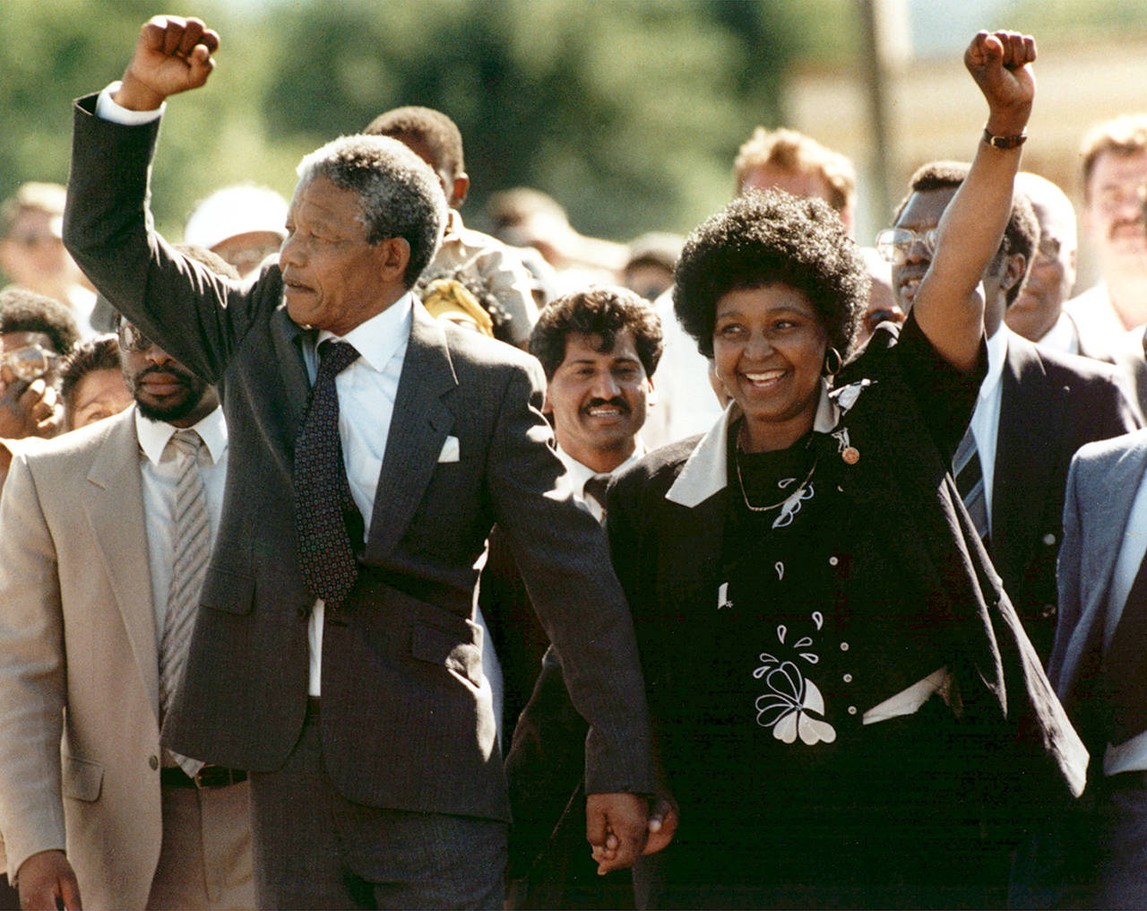 In this Feb. 1990 photo, Nelson Mandela and his wife, Winnie, walk hand in hand, raising their clenched fists upon his release from Victor prison, Cape Town, 27 years in detention. (AP Photo, file)
