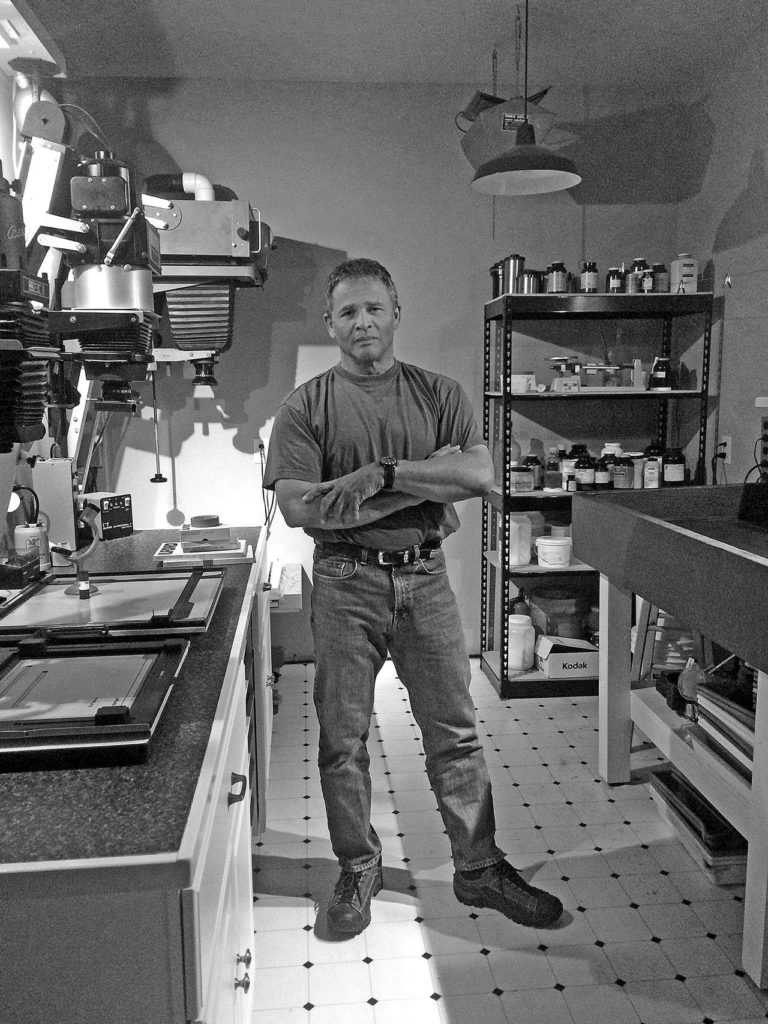 Norman Riley in his Bellingham darkroom, where he processes film and makes his own prints with traditional photographic methods.
