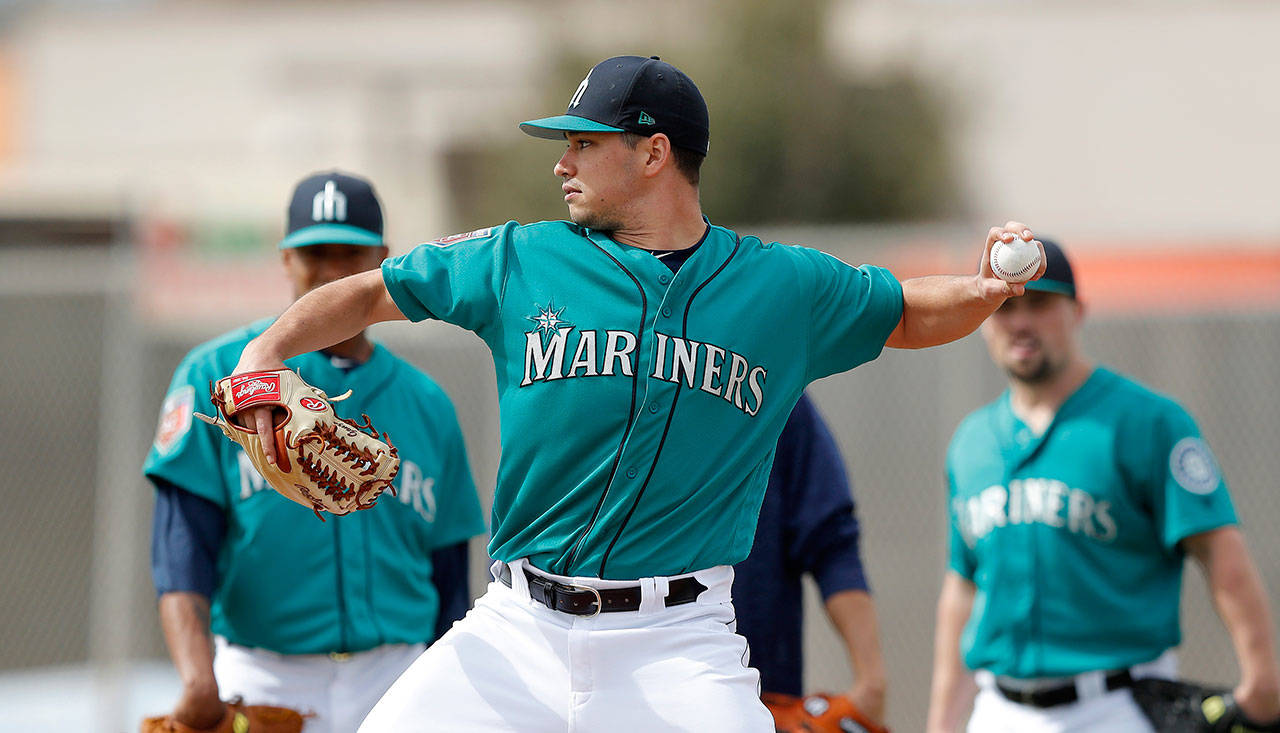 Seattle’s Marco Gonzales throws to second base during a drill in spring training on Feb. 19 in Peoria, Arizona. (AP Photo/Charlie Neibergall)