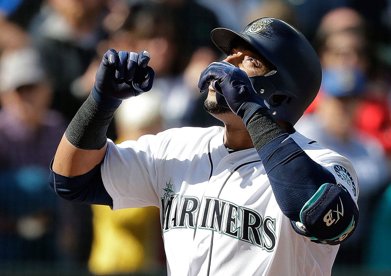 Mariners designated hitter Nelson Cruz looks up as he crosses home plate after hitting a two-run home run against the Cleveland Indians during the sixth inning of Saturday’s game against the Cleveland Indians in Seattle. (AP Photo/Ted S. Warren)