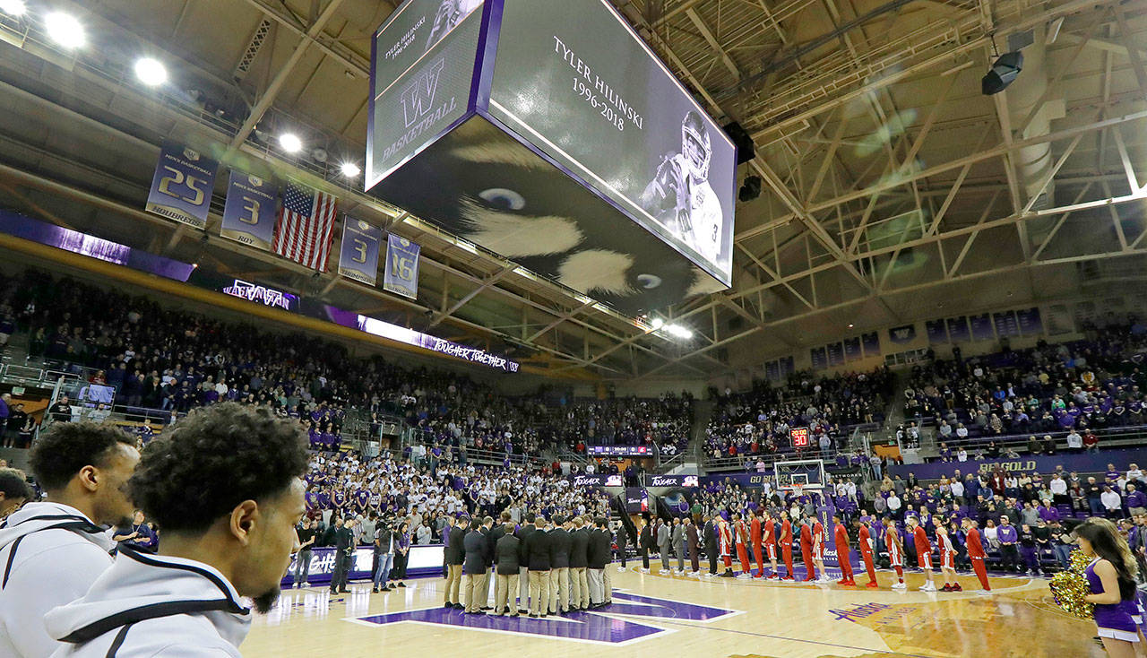 The Washington and Washington State men’s basketball teams observe a moment of silence before a Jan. 28 game in Seattle following the death of WSU quarterback Tyler Hilinski. (AP Photo/Ted S. Warren)